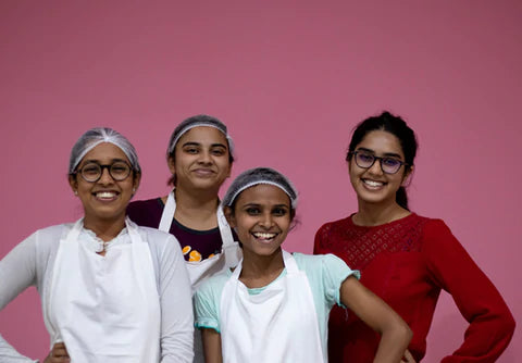 CEO and Founder and Chefs of Dream a Dozen Smiling at the Camera. 100% Eggless Bakery. All Women Kitchen. Made from scratch.