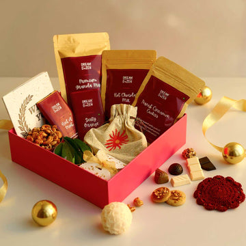 Gourmet gift box with snacks and treats on a light background