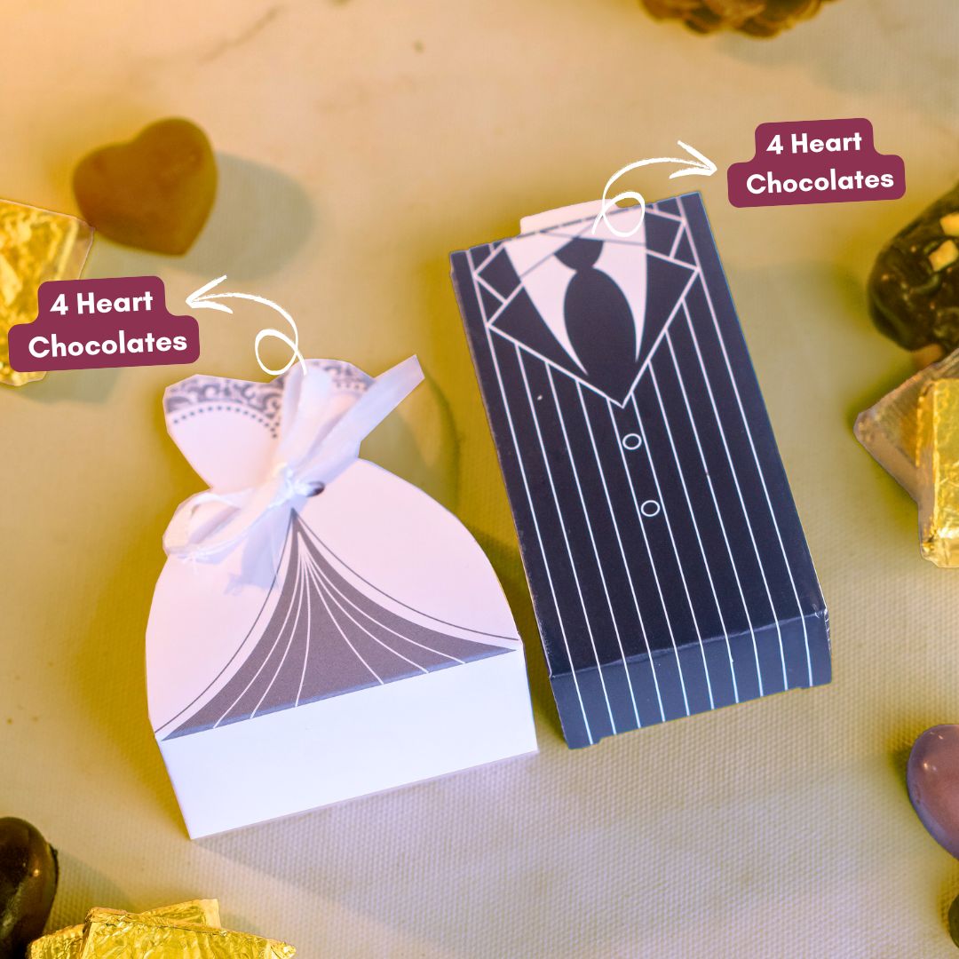 a top shot of a bridal dress box and tuxedo filled with 4 delicious heart shaped chocolates that are the perfect wedding chocolate gift favours