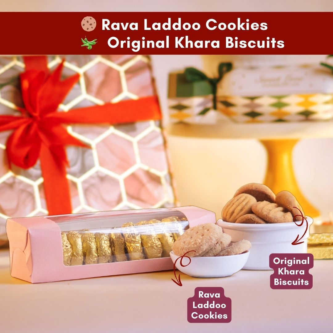 a close up front shot of a cup of original khara biscuits and another cup of rava laddoo cookies with a semi transparant box of the same cookies wrapped in gold
along with the entire hamper in the background