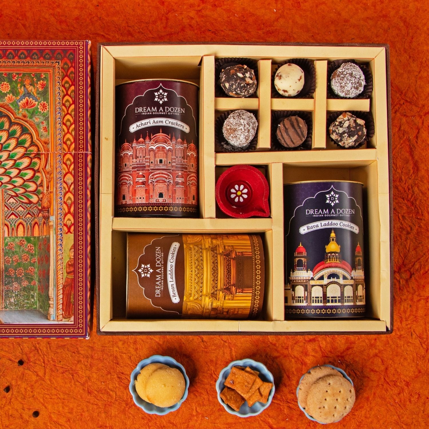 Assorted cookies in a decorative box on an orange background