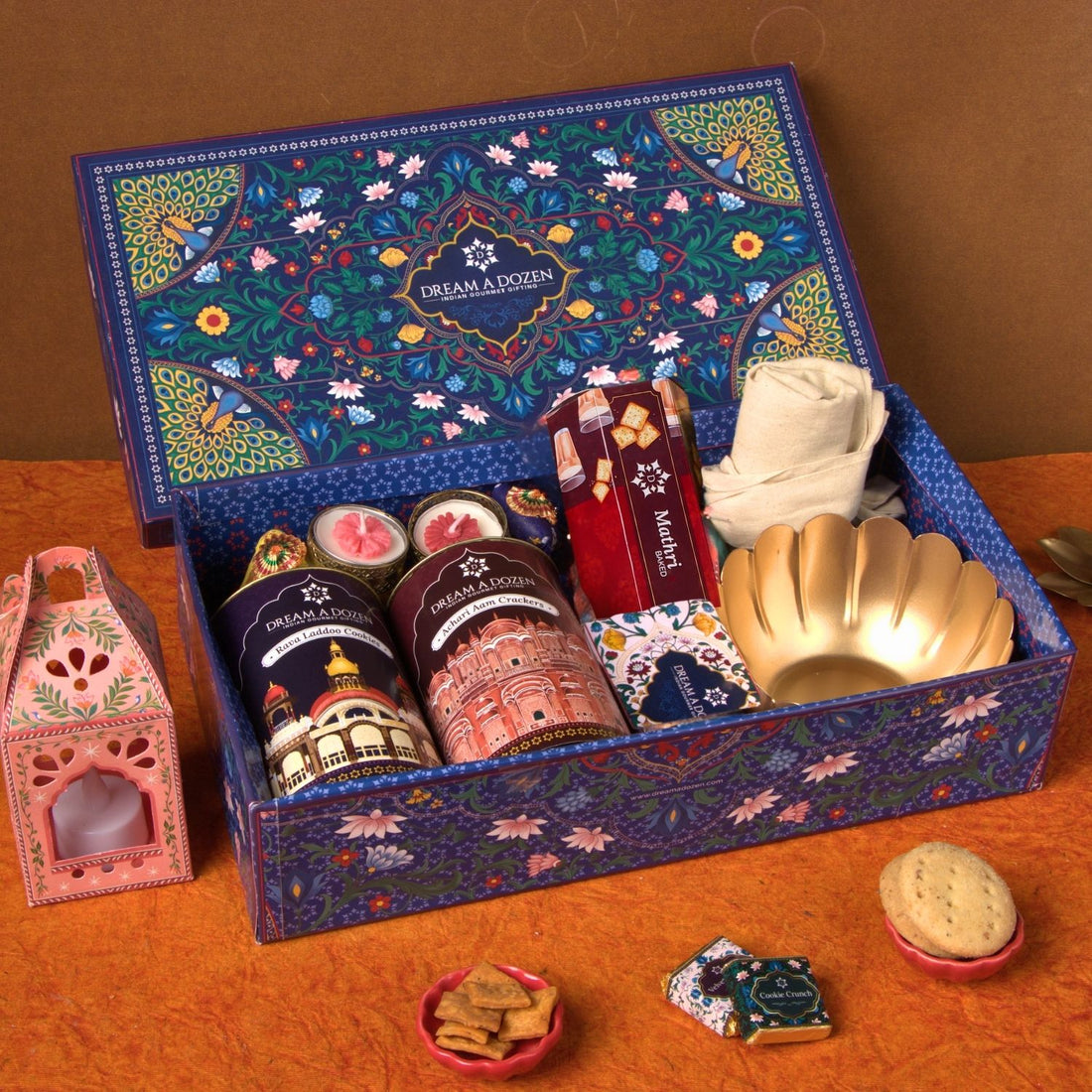 Decorative gift box with various items on a wooden surface
