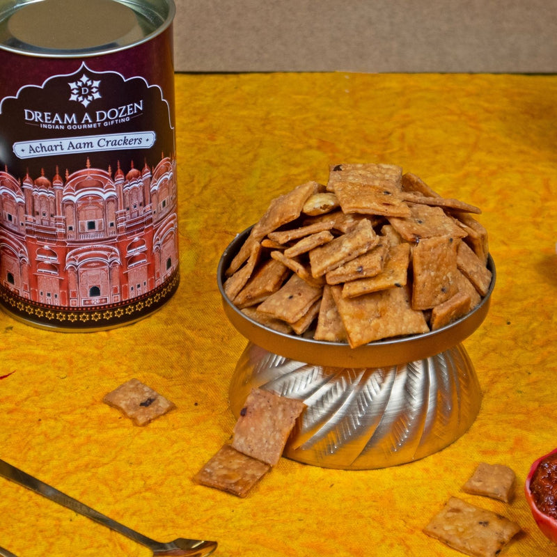 Dream a Dozen Indian gourmet crackers in a decorative container on a yellow surface