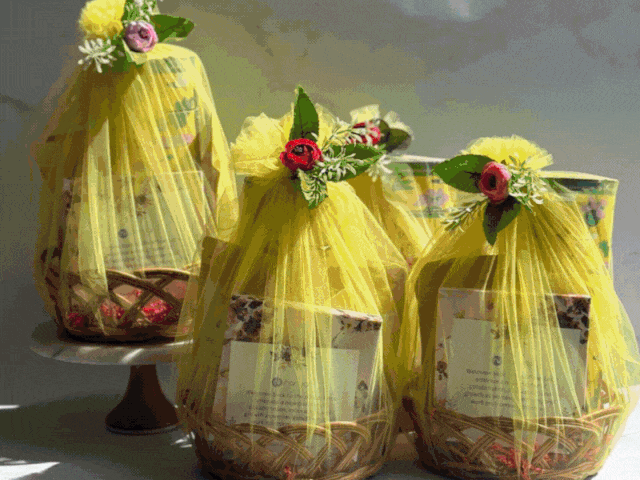 A gif of our team packaging Christmas & New Year Gift hampers and logo branded corporate gifts. It shows ladies in pink aprons baking our desi gourmet cookies, crackers, chocolates and nuts from scratch with no added preservatives
