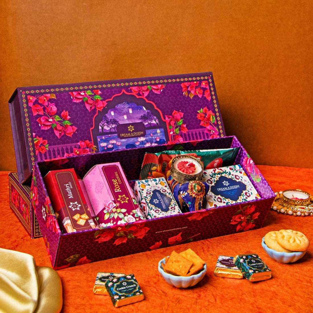 Decorative gift box with snacks on an orange surface