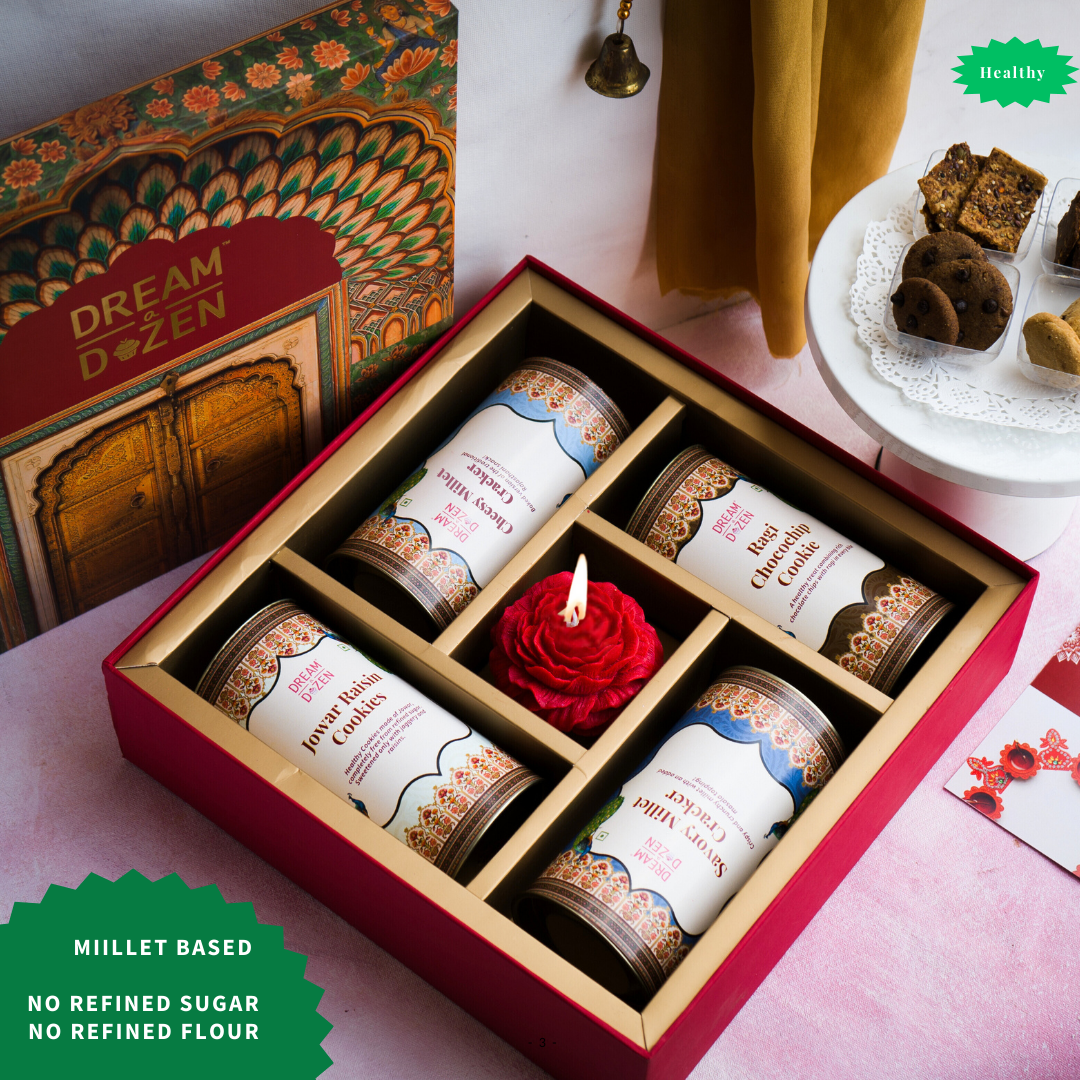 A top-down shot of our thoughtfully curated 12-inch box hamper with desi nostalgic and healthy, flavoured cookies and merchandise, perfect for  health-conscious and older guest recipients under 2500. It's not made with refined sugar or FLOUR.  healthy wedding gift hamper for friends and family. best return gift. 