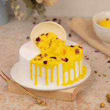 Load image into Gallery viewer, Pieces of rasmalai and pista spilling on top of the eggless cake made with fresh rasmalai pieces

