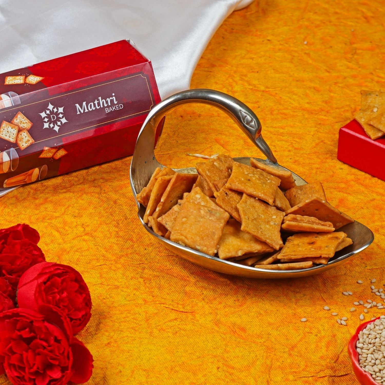 Bowl of crackers with Mathri Baked packaging on a yellow background