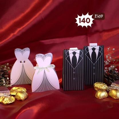 Elegant bride and groom wedding favor boxes with 100% eggless heart-shaped chocolates – two dark cookie crunch and two milk crackles in each. Perfect budget-friendly marriage gift with PAN India shipping, set on a wooden table with fairy lights and golden floral decor