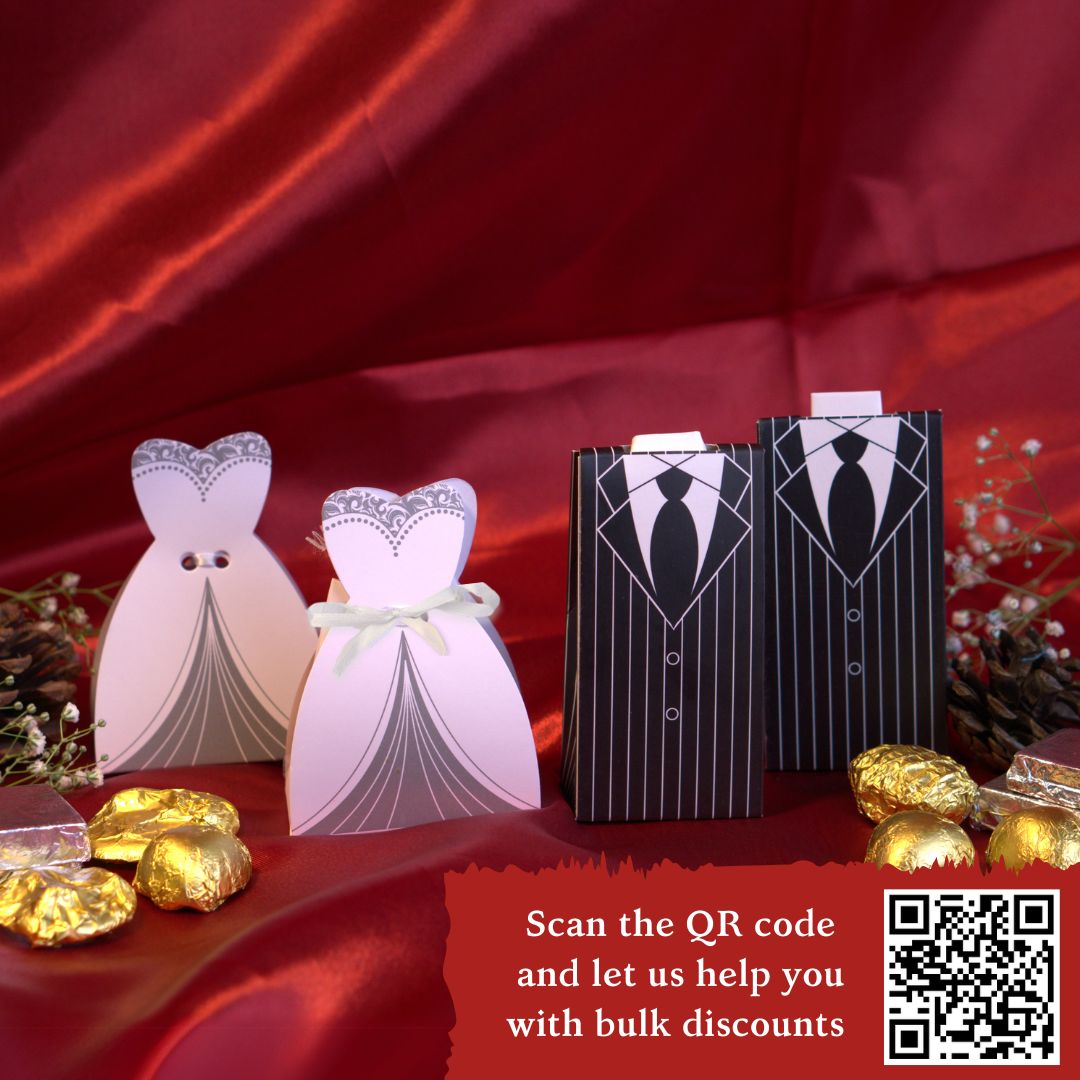 Elegant bride and groom wedding favour boxes with 100% eggless heart-shaped chocolates – two dark cookie crunch and two milk crackles in each. Perfect budget-friendly marriage gift with PAN India shipping, set on a wooden table with fairy lights and golden floral decor