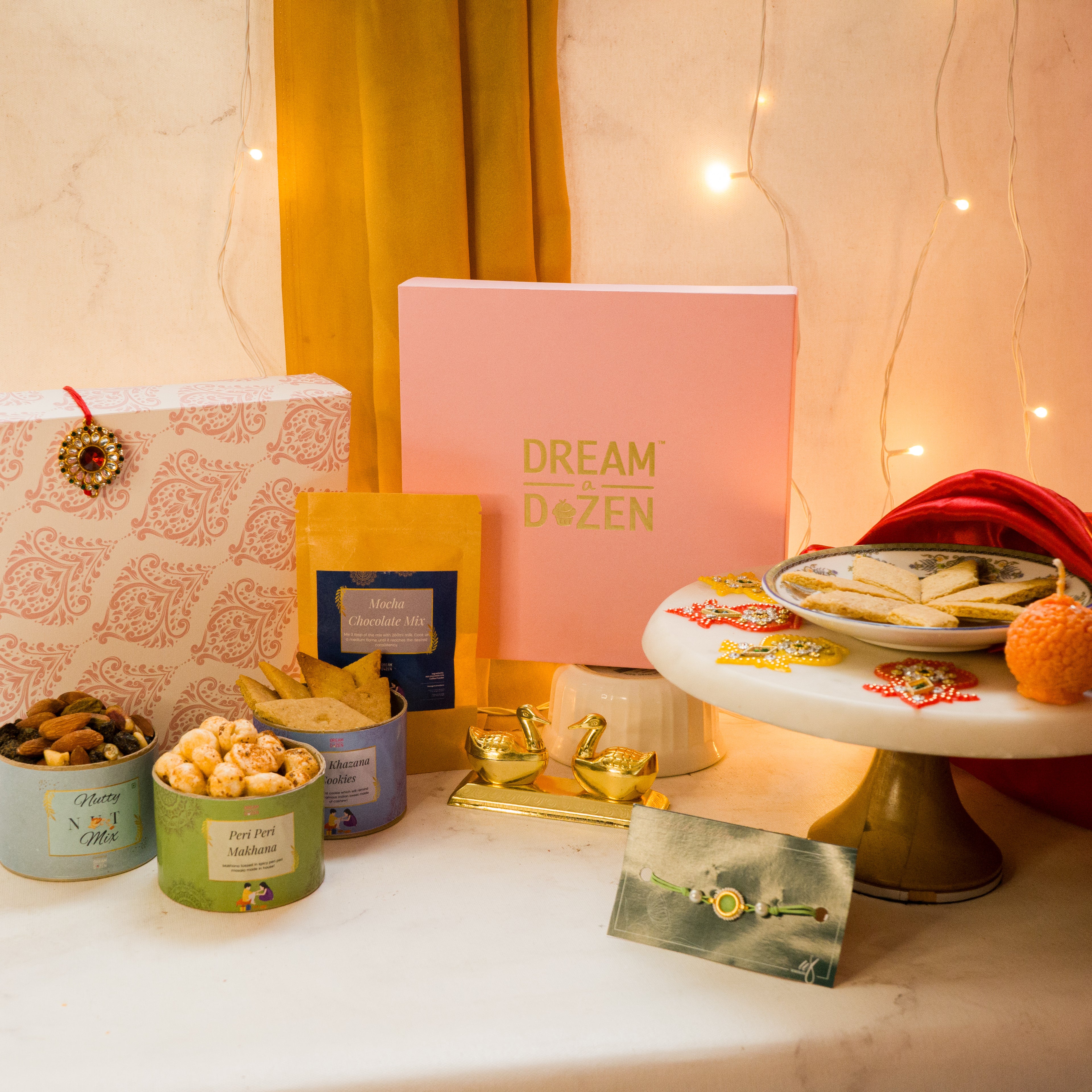 Raksha Bandhan Gift for Bhabhi and Bhaiyya. Taken from a top angle, the hamper is for both brother and sister-in-law, has hamper products meant for tea time and also has a rakhi