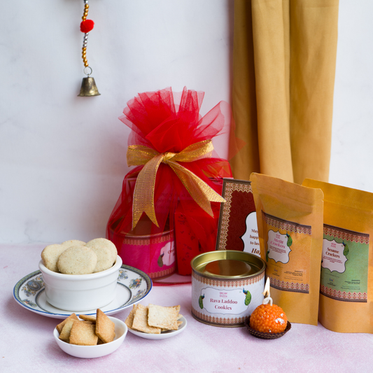 A cute festive potli packaging consisting of our best selling Rava Laddoo Cookies and sesame crackers, ideal for wedding return gift hamper under ₹1000.  best wedding gift hamper. 