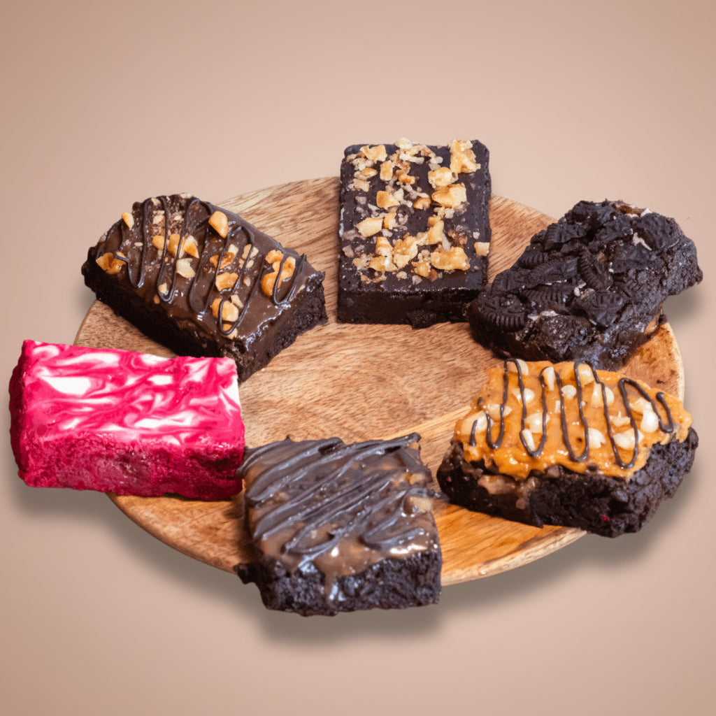 top shot of a  mixed pack of our best brownie flavors - red velvet swirl, fudgy walnut, peanut butter crunch, Nutella hazelnut, caramel sea salt, and Oreo!
