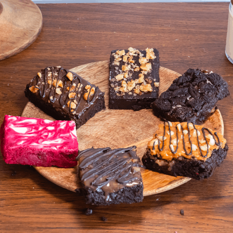 top shot of a  mixed pack of our best brownie flavors - red velvet swirl, fudgy walnut, peanut butter crunch, Nutella hazelnut, caramel sea salt, and Oreo!