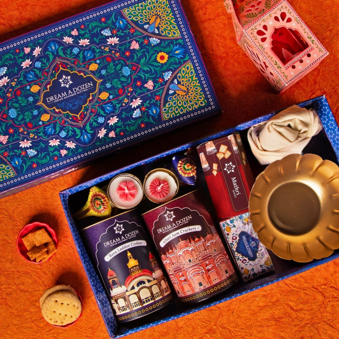 Decorative gift box with various items on a wooden surface