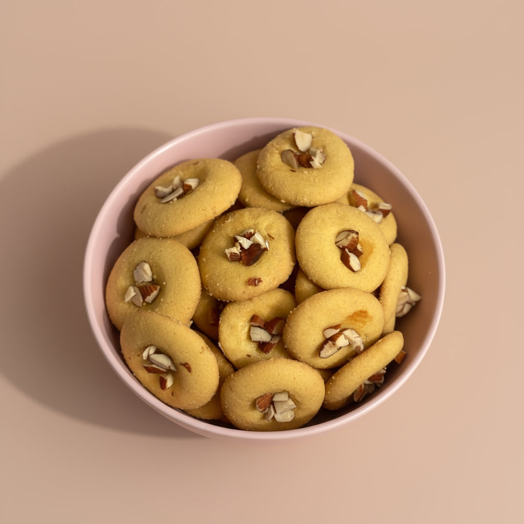 Cookies on a stand with honey being drizzled over them, next to a can of cookies.