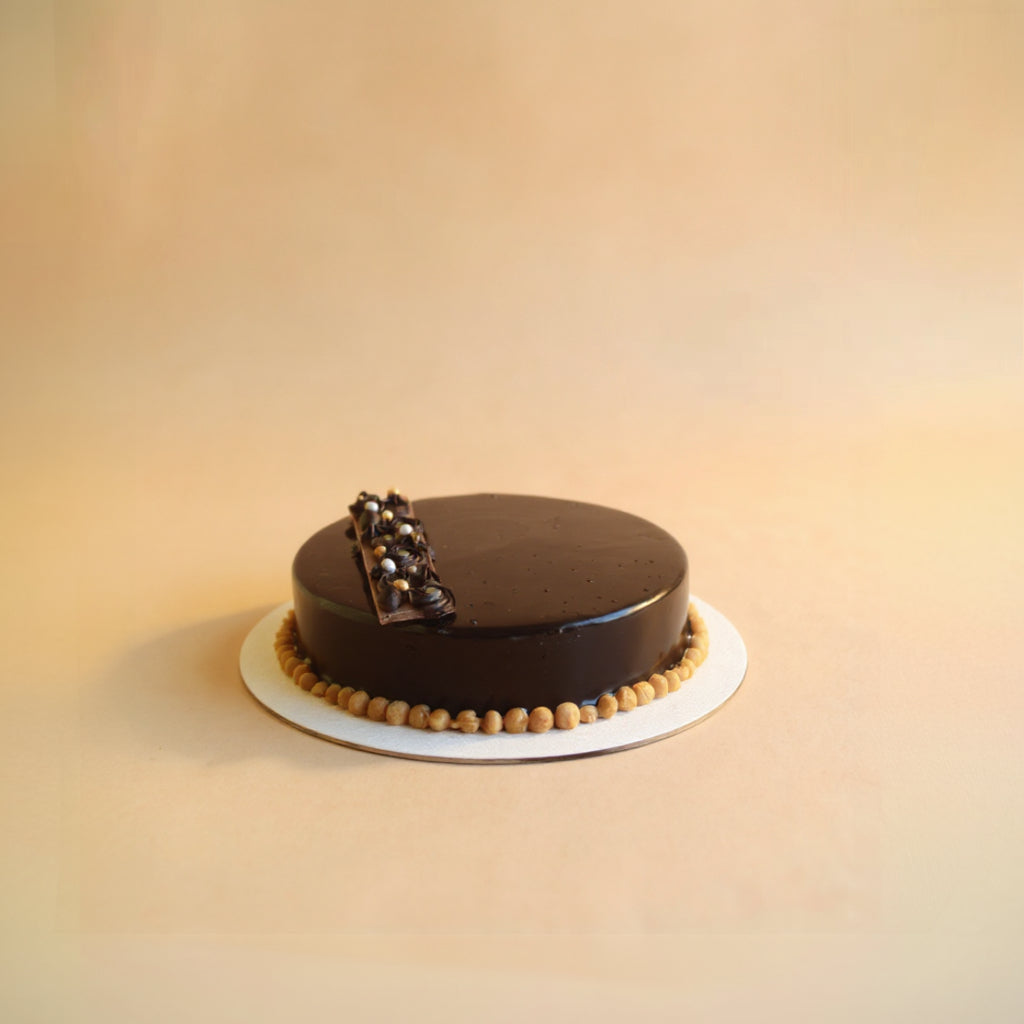 Chocolate cake with decorative elements on a beige background