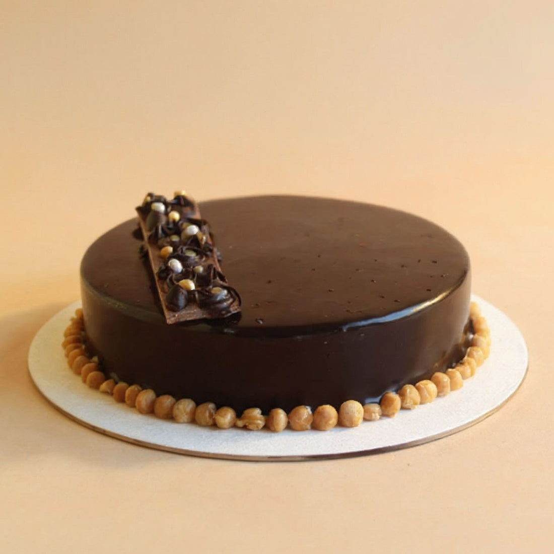 Chocolate cake with a decorative element on a beige background