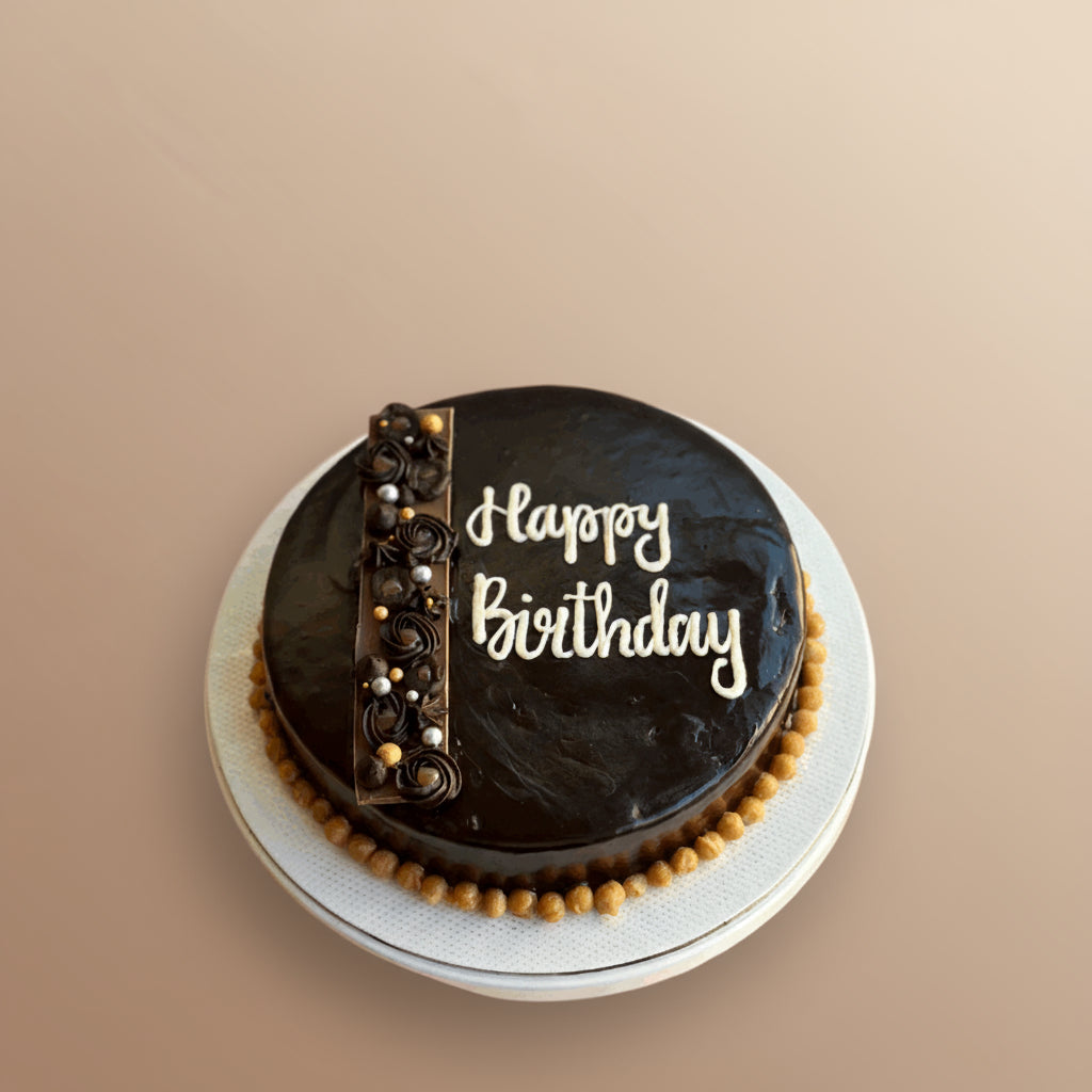 Chocolate cake with decorative elements on a beige background