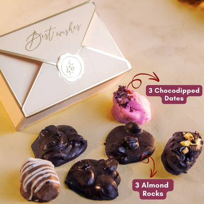 a close up side shot of delicious looking contents of the elegant beige and golden box which is 3 chocodipped dates and 3 almond rocks 
they serve as the perfect scrumptious treats for a wedding gift