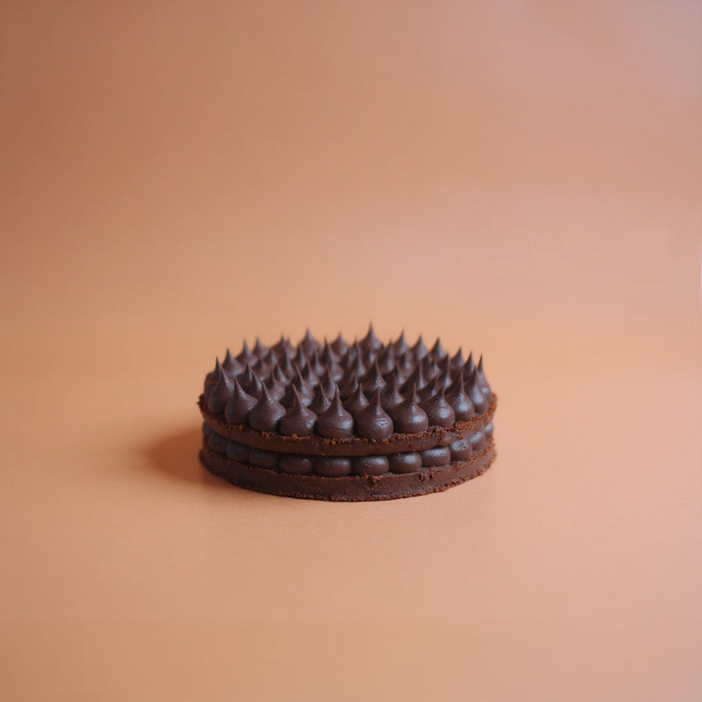 Chocolate cake with a unique texture on a beige background