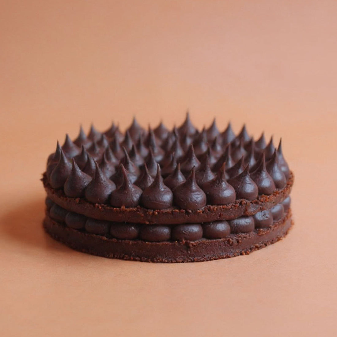 Chocolate cake with a unique topping on a beige background