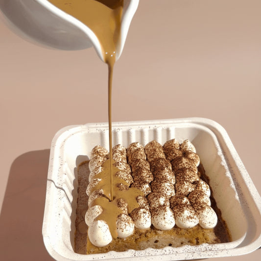 Coffee Tres leches with some coffee pouring on it