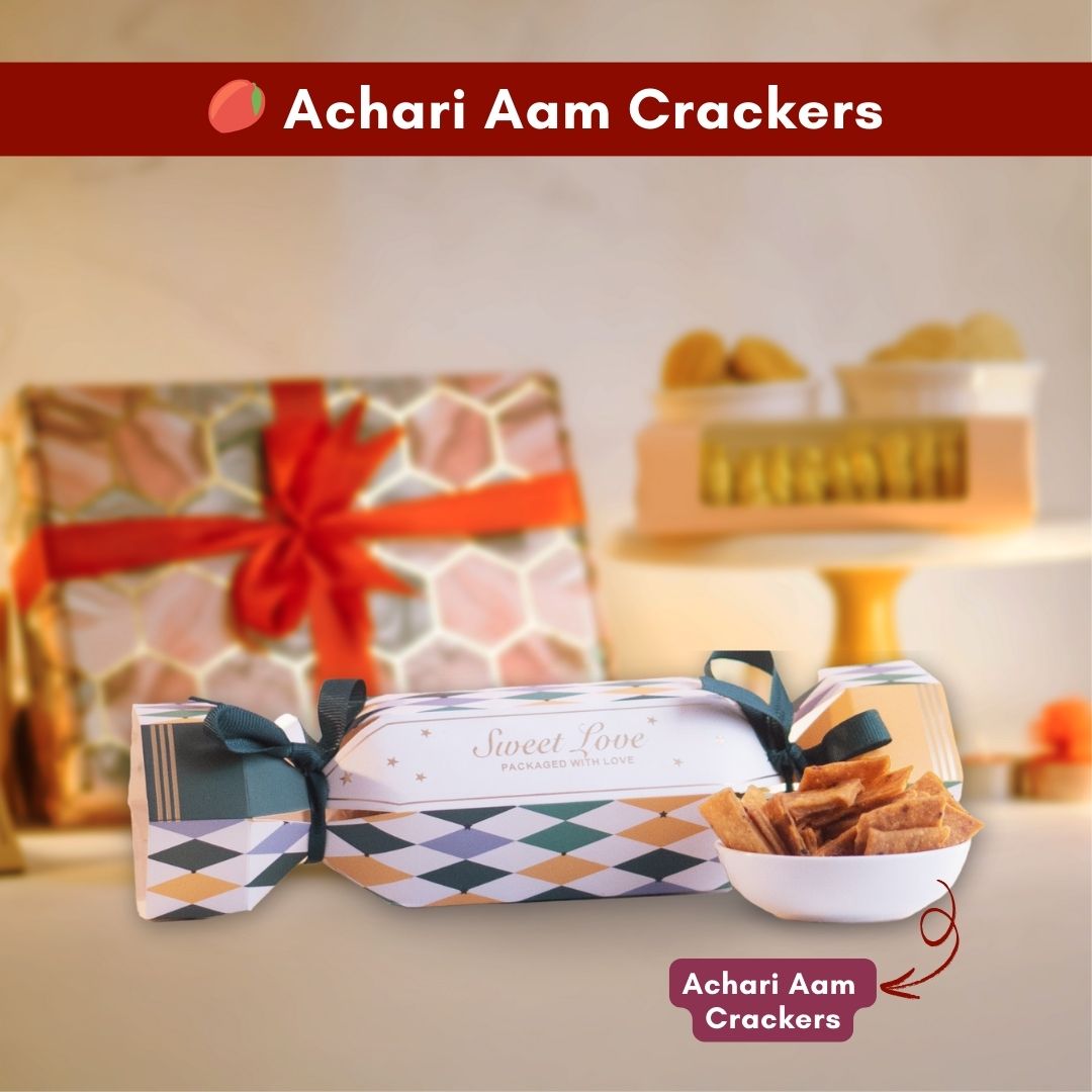 a close up front shot of a candy shaped packaging with a bowl of inviting achari aam crackers in front of it 