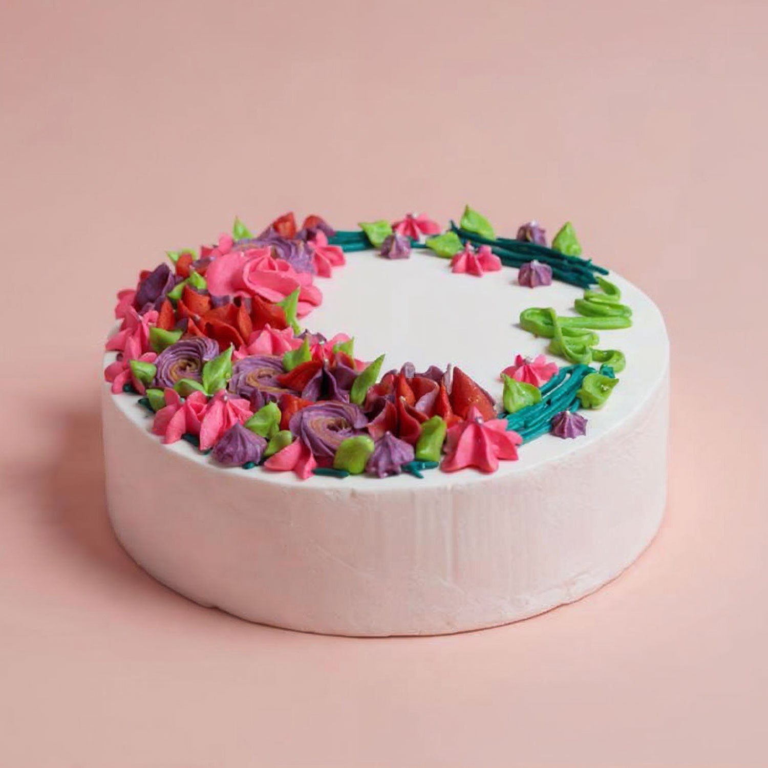 Colorful flower-shaped cake on a pink background