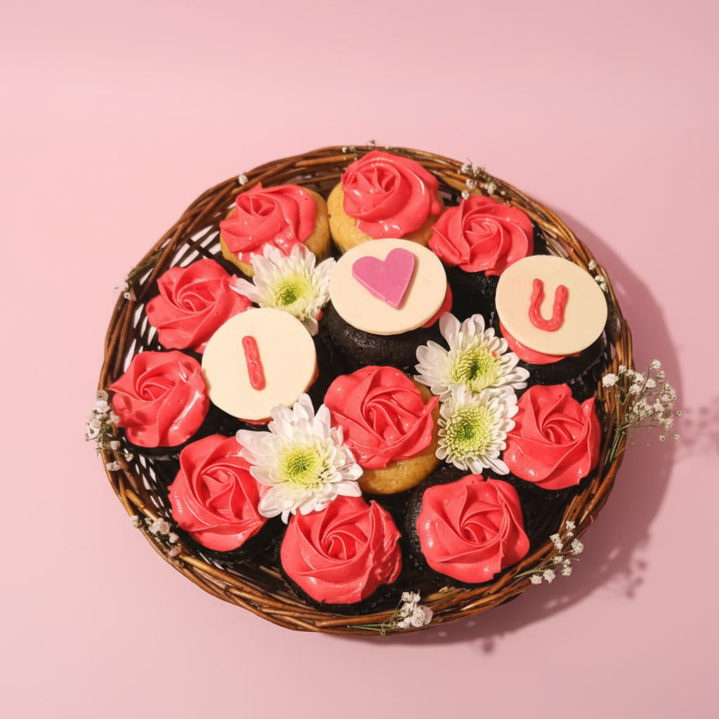 A floral cupcake basket with pink frosting and I love You message