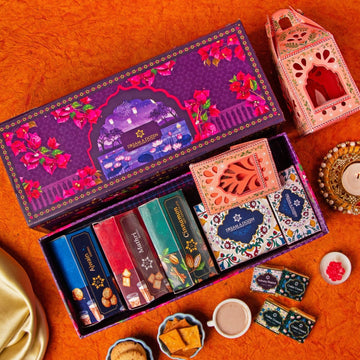 Decorative chocolate box with colorful packaging on an orange surface