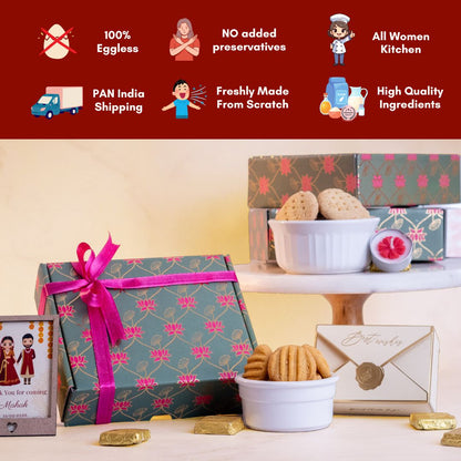 a full shot of the hamper and all its contents around it including a customisable mini photo frame, a bowl of rava laddoo cookies, a bowl of original khara biscuits, a floral tea light candle and an elegant envelope box 
there is an infographic above that shows that the product is 100% eggless, contains no added preservatives, is made in an all women kitchen, has PAN India shipping, is freshly made from scratch using high quality ingredients