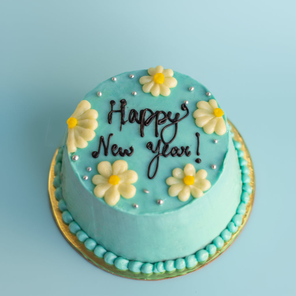 Turquoise cake with decorative elements on a white background