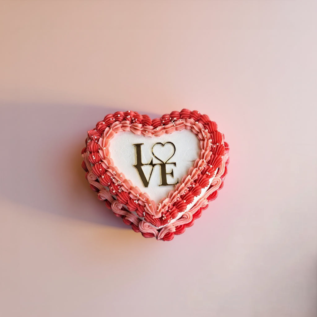 Heart-shaped cookie with 'LOVE' decoration on a light pink background