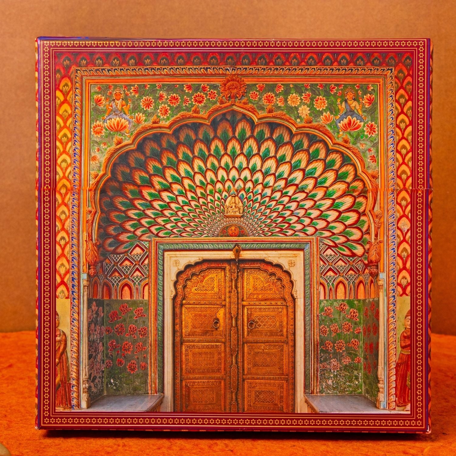 Decorative box with intricate design of a wooden door and archway on an orange background