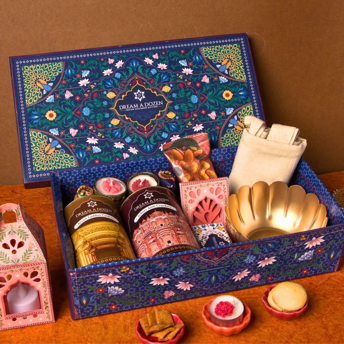 Decorative gift box with various items on a wooden surface