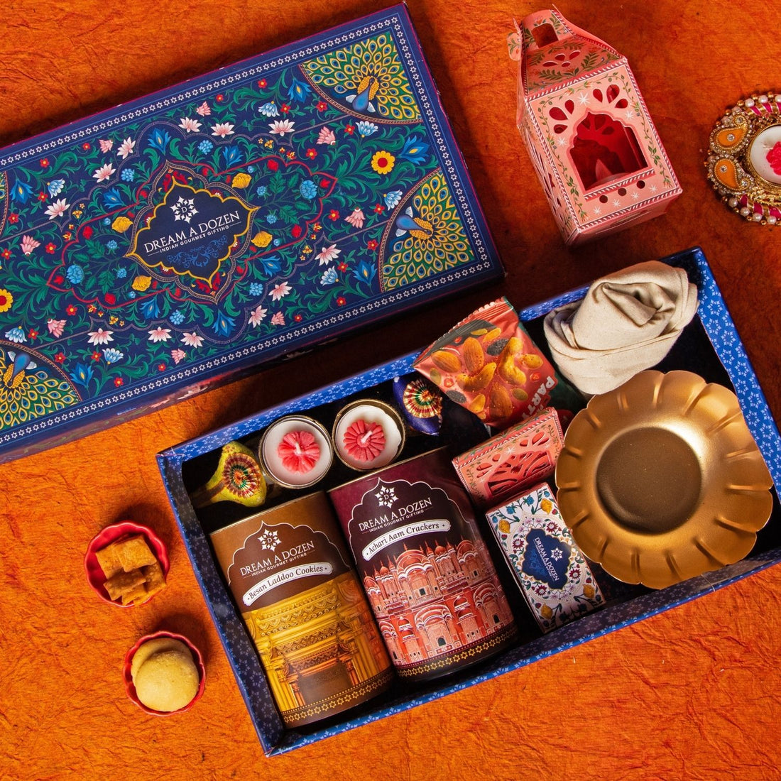 Decorative gift box with various items on a wooden surface