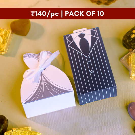 a top down shot of a white bride dress box next to a tuxedo groom box with chocolates sold at ₹129 per piece in a pack of 10