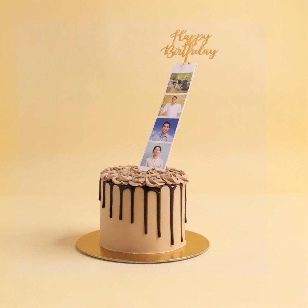 Birthday cake with a photo rolling strip and 'Happy Birthday' topper on a yellow background