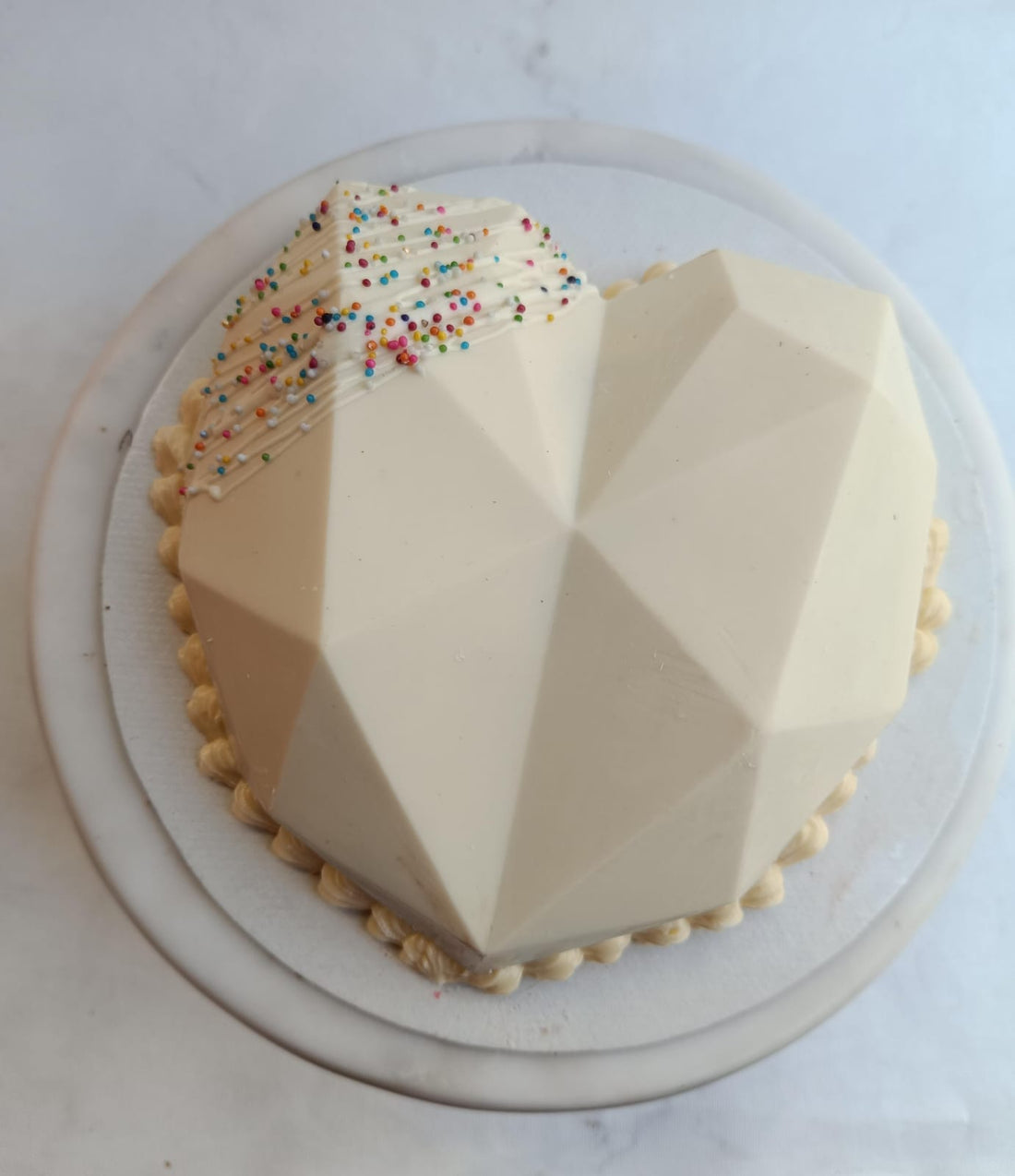 strawberry pinata cake loaded with fresh strawberry between layers of red velvet and luscious cream cheese frosting available for home delivery in bangalore