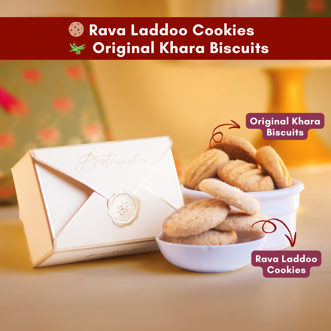 a close up direct shot of an elegant envelope box with gold borders beside two cups of delicious looking rava laddoo cookies and original khara biscuits