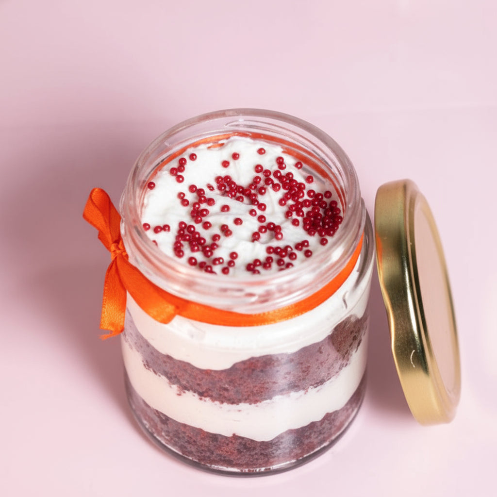 Layers of red velvet cake and cream cheese frosting in a dessert jar!