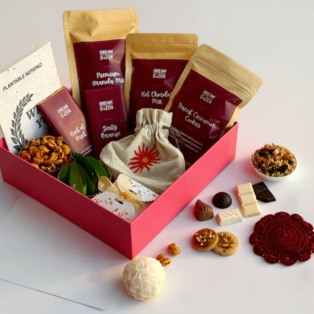 Gourmet gift box with snacks and treats on a light background