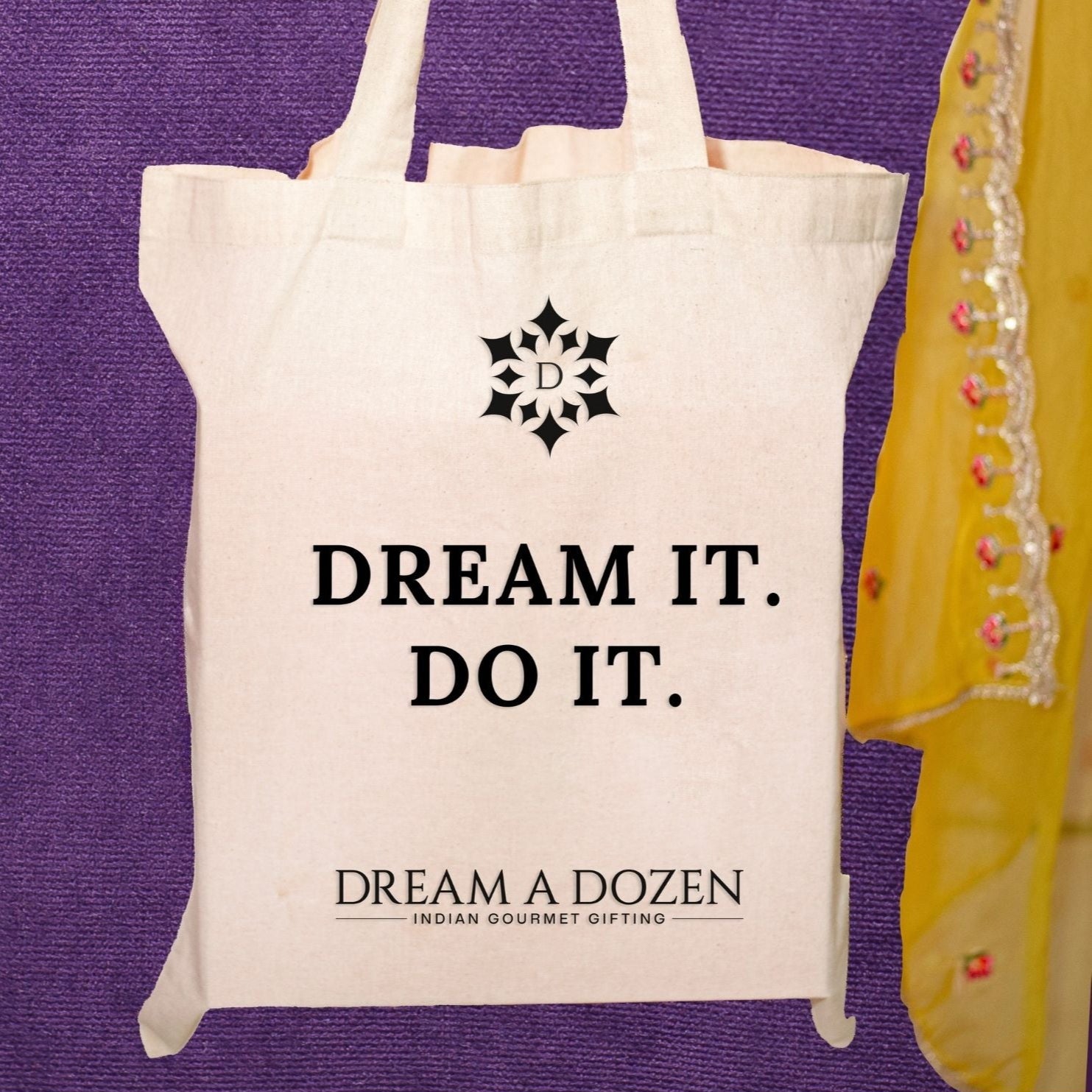 Tote bag with 'Dream It. Do It.' text and logo on a purple background