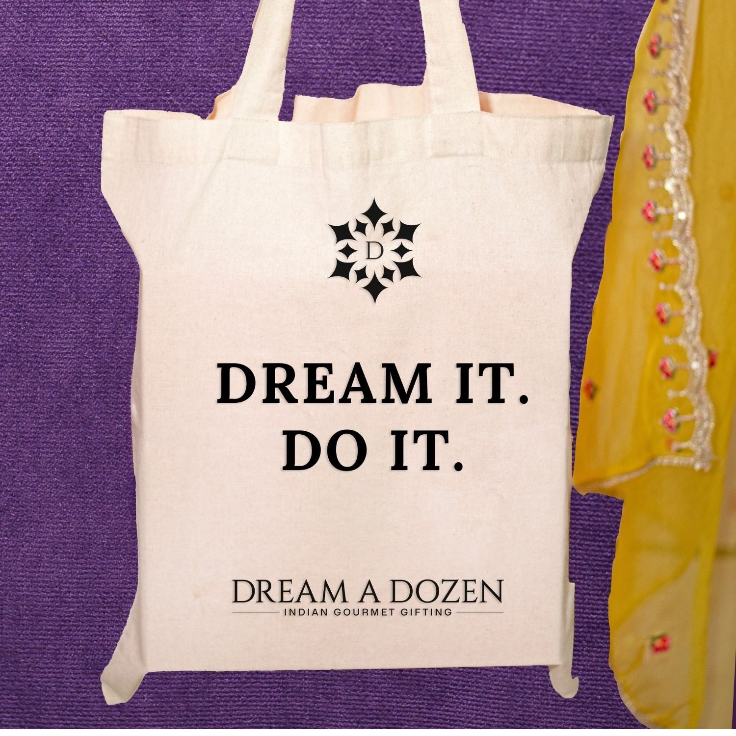 Tote bag with 'Dream It. Do It.' text and logo on a purple background