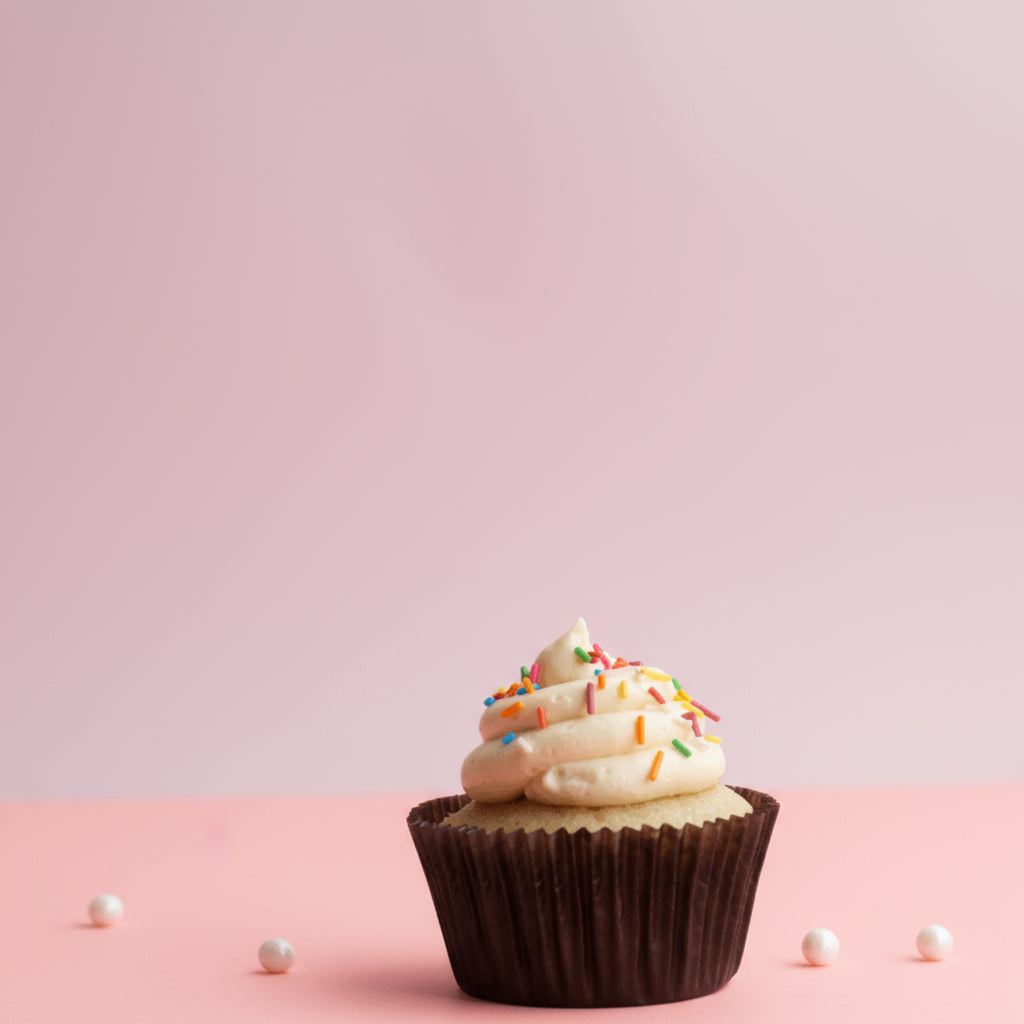 Vanilla Buttercream Cupcake with a candle on it