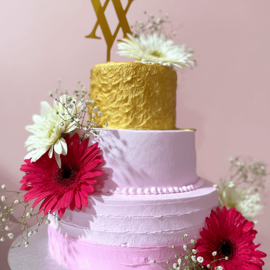 wedding cake with golden tier and white and red flowers