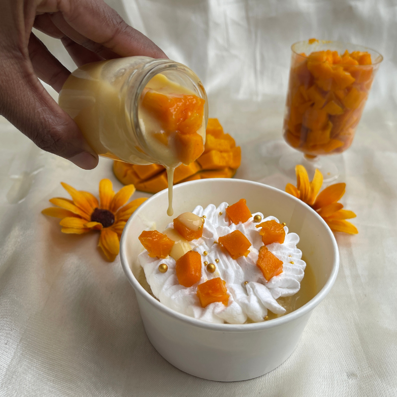 Twisted Spanish dessert. Sponge soaked in mango milk topped with fresh cream and mango chunks.
